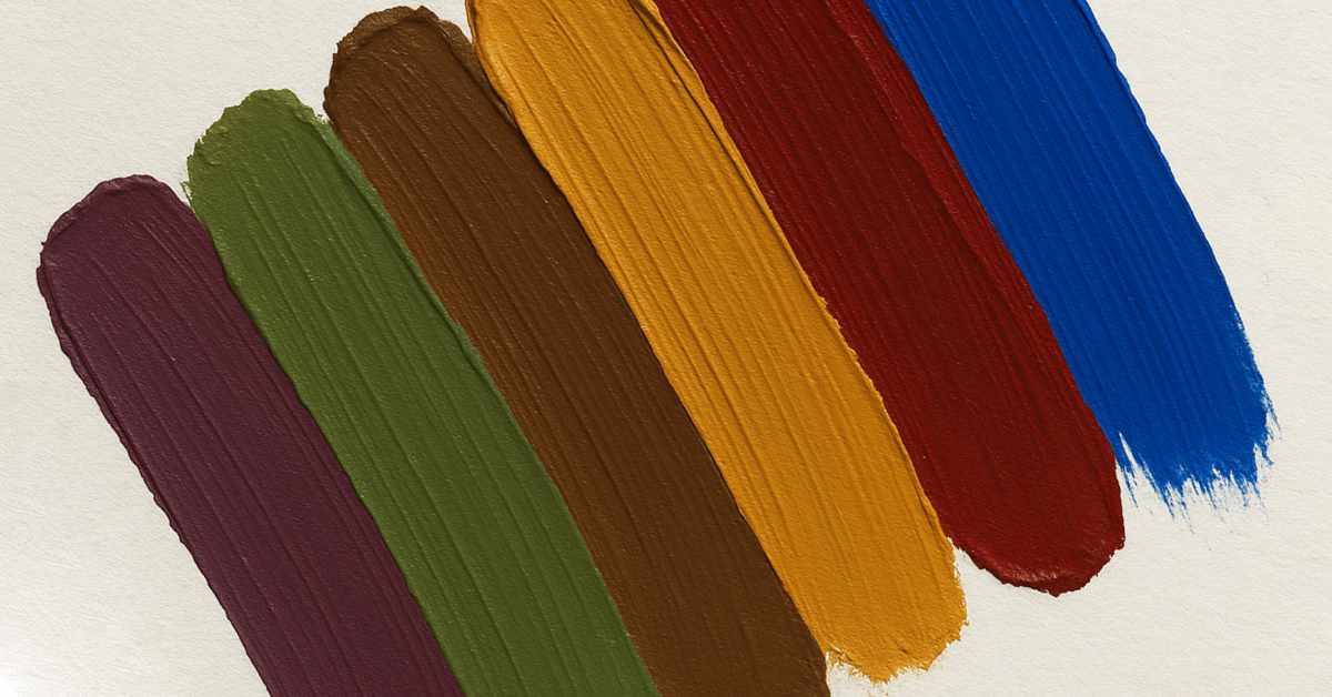 Six thick, vertical paint swatches are applied side by side on a white surface. From left to right, the colors are: dark mauve, olive green, chocolate brown, mustard yellow, brick red, and royal blue. The paint has a textured, brushstroke appearance.